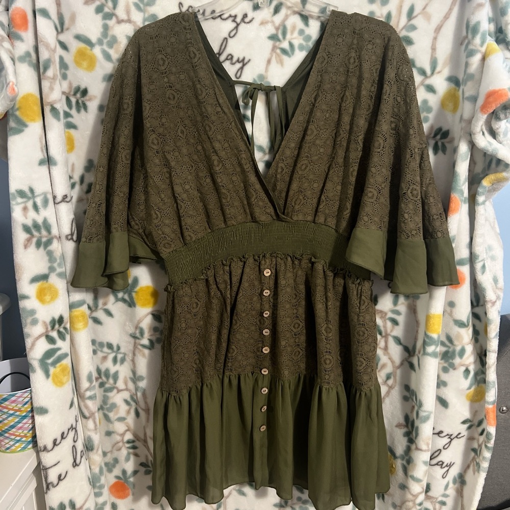 Large v neck lace crotchet mini dress with batwing flowy sleeves. Ties in back.